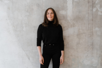 CEO der Strategieberatung diffferent Kristina Bonitz lehnt an einer Wand und schaut in die Kamera